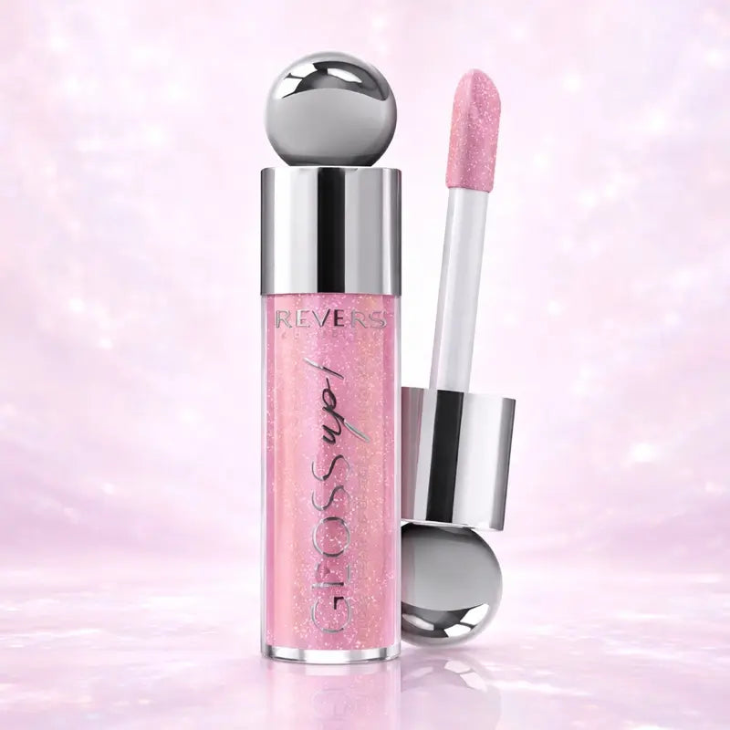 Gloss up! Pink lip gloss with silver cap and applicator on a pink background