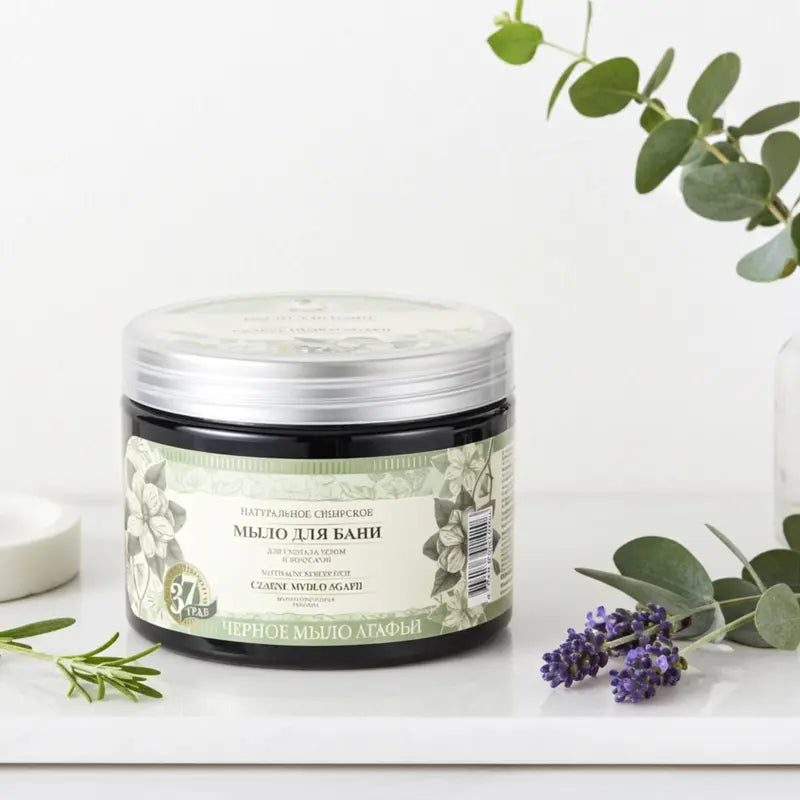 Jar of natural Siberian Grandma Agafia Black Soap with decorative elements on a light background