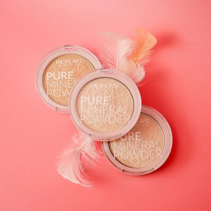 Three compact face powders with feathers on a pink background