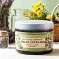 Jar of natural Siberian Grandma Agafia Black Soap with decorative elements on a light background