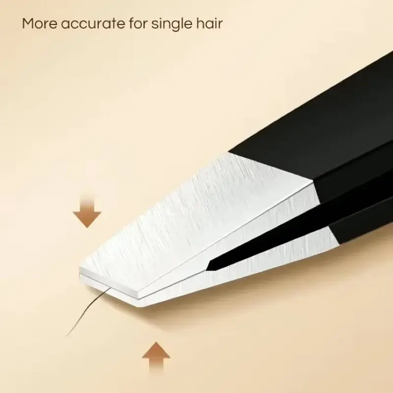 Black hair removal tool with a single hair being pulled, on a beige background.