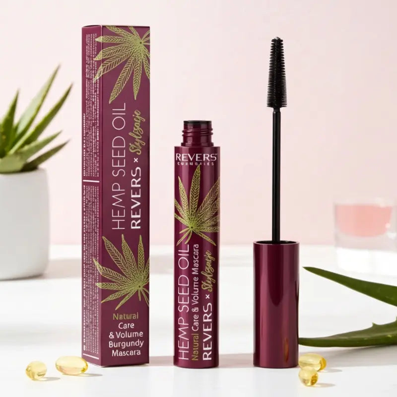 Burgundy Hemp Seed Oil mascara with packaging and green leaf design on a light background